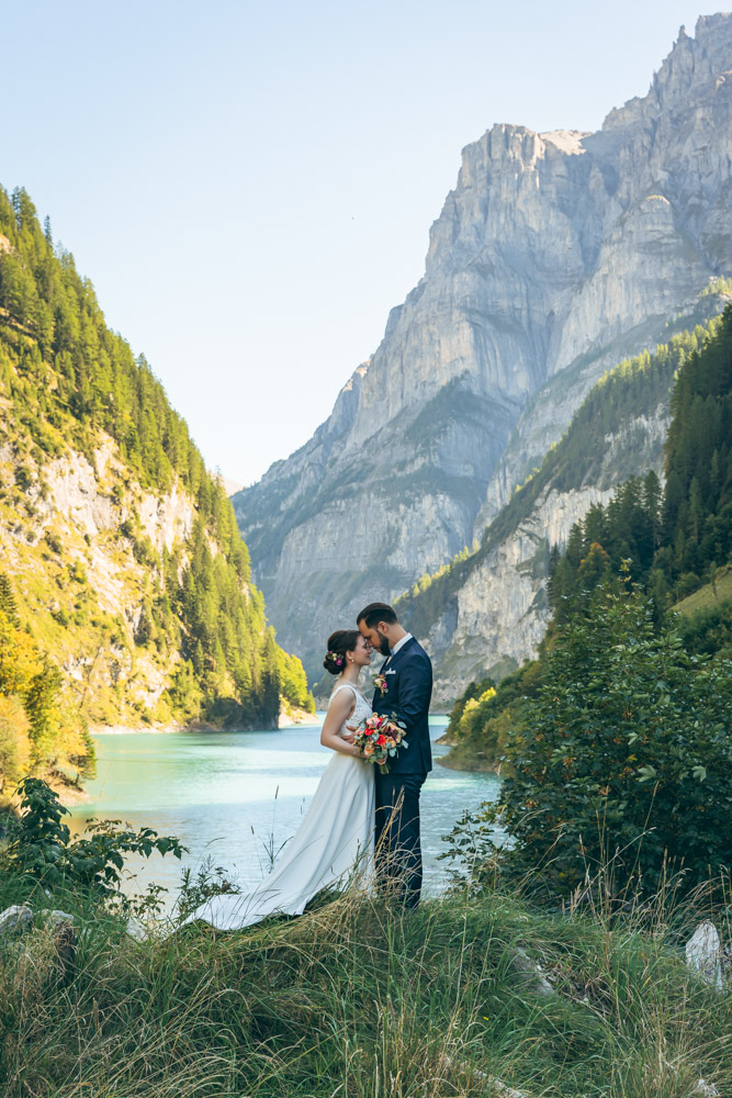 Berghochzeit in Graubünden am Bergsee Brautpaar bei einer Berghochzeit in Graubünden vor türkisfarbenem Bergsee und imposanter Alpenkulisse – fotografiert von Christian Meixner, Hochzeitsfotograf aus Zürich.